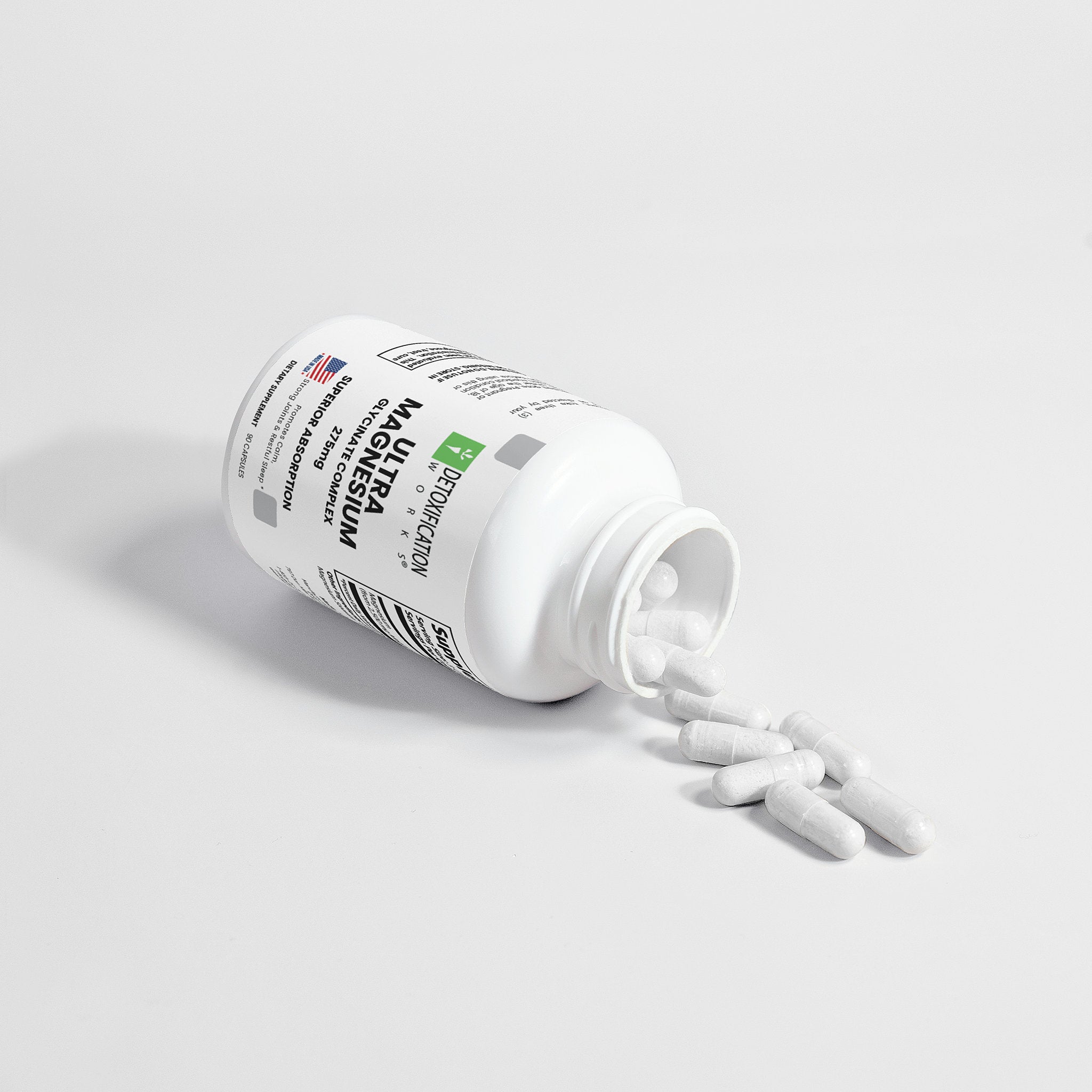 Supplement bottle labeled 'Ultra Magnesium' with pills spilling out on a light gray background